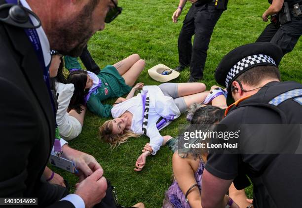 Animal rebellion activists are arrested after running onto the racecourse, on day two of the Epsom Derby, on June 04, 2022 in Epsom, England. The...