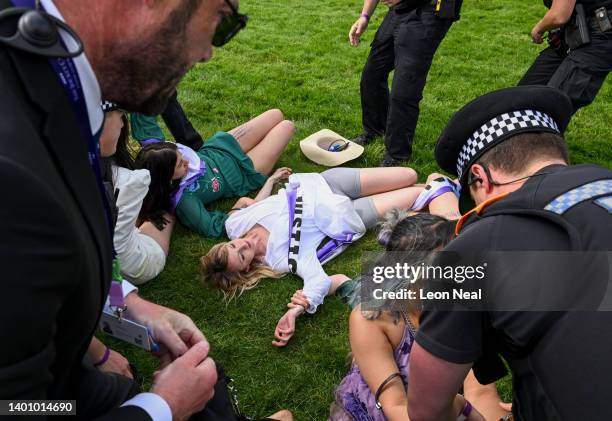 Animal rebellion activists are arrested after running onto the racecourse, on day two of the Epsom Derby, on June 04, 2022 in Epsom, England. The...