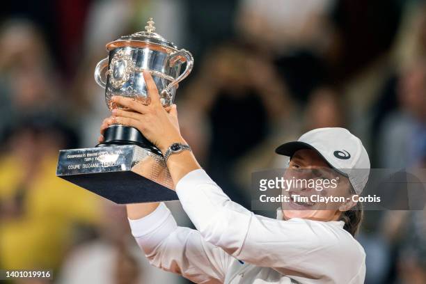 Iga Swiatek of Poland with the winners trophy after her victory against Coco Gauff of the United States during the Singles Final for Women on Court...