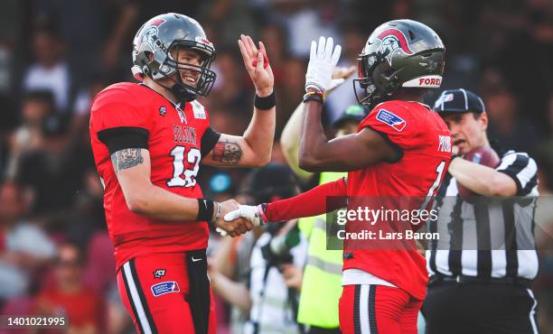 Jan Frank Weinreich celebrates with Quinten Pounds of Cologne after scoring a touch down during the European League of Football match between Cologne...