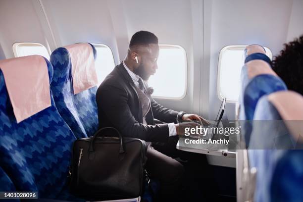 businessman working on presentation during flight - comfortable flight stock pictures, royalty-free photos & images