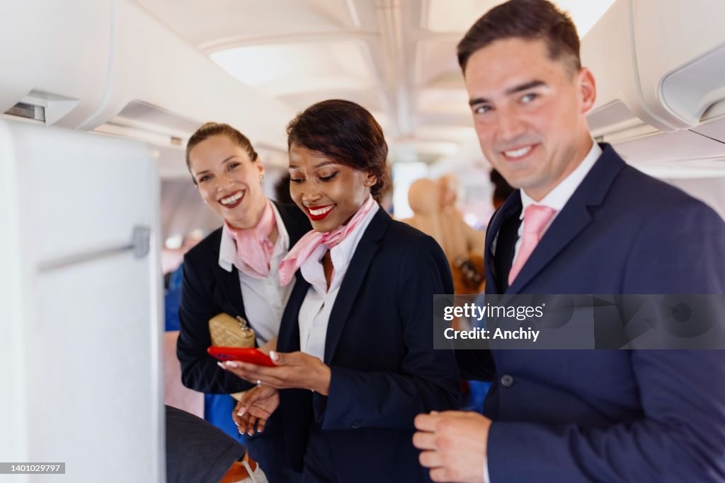 Portrait of a smiling cabin crew members during disembarking