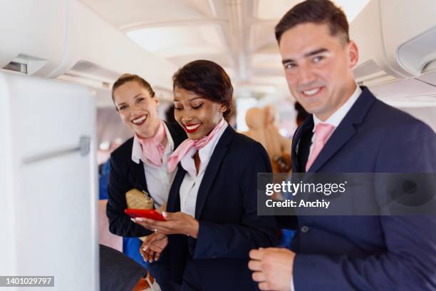 portrait of a smiling cabin crew members during disembarking - flight attendants stock pictures, royalty-free photos & images