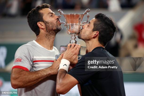 Jean-Julien Rojer of Netherlands and partner Marcelo Arevalo of El Salvador celebrate with the trophy after winning against Ivan Dodig of Croatia and...
