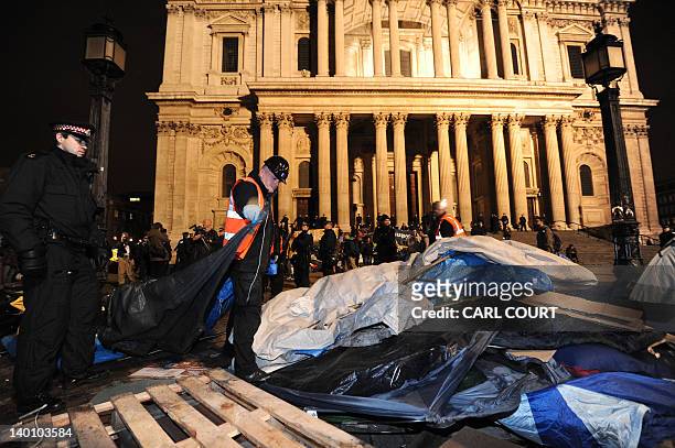Tents are cleared away from the Occupy protest camp outside Saint Paul's Cathedral in central London, early on February 28 as police and bailiffs...