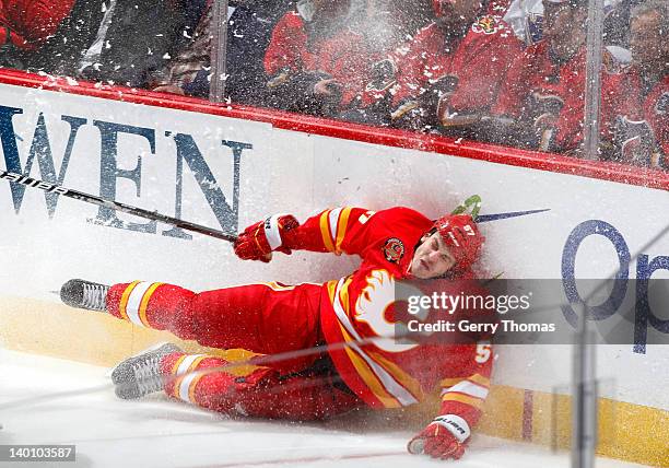 Lance Bouma of the Calgary Flames lands hard against the boards during the game against the St. Louis Blues on February 27, 2012 at the Scotiabank...