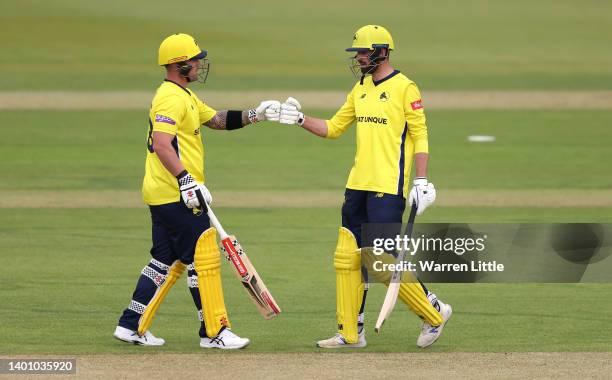 Ben McDermott and James Vince of Hampshire Hawks fist pump during the Vitality T20 Blast between Hampshire Hawks and Sussex Sharks at Ageas Bowl on...