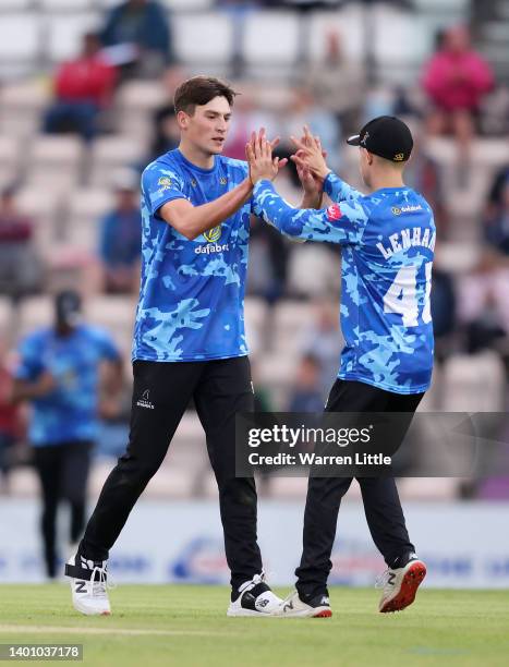 Henry Crocombe of Sussex Sharks is congratulated by team mate Archie Lenham of Sussex Sharks after bowling James Vince of Hampshire Hawks during the...