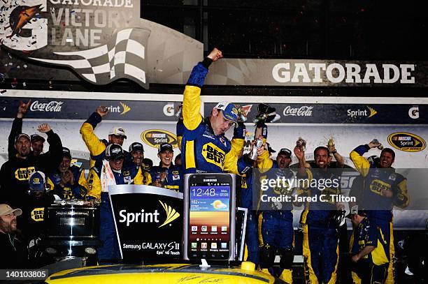 Matt Kenseth, driver of the Best Buy Ford, celebrates in Victory Lane after winning the NASCAR Sprint Cup Series Daytona 500 at Daytona International...