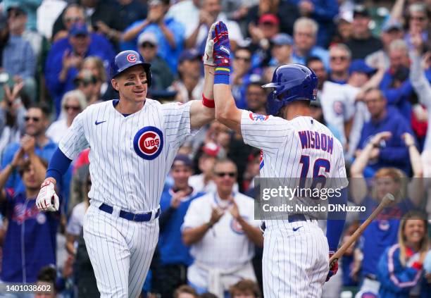 Frank Schwindel of the Chicago Cubs is congratulated by Patrick Wisdom of the Chicago Cubs following a home run during the fifth inning of Game One...