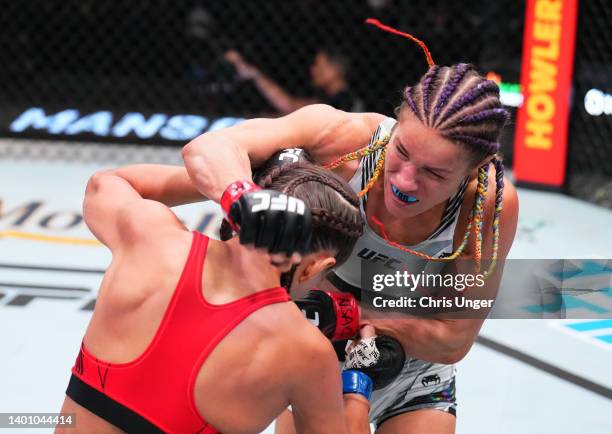 Felice Herrig punches Karolina Kowalkiewicz of Poland in a strawweight fight during the UFC Fight Night event at UFC APEX on June 04, 2022 in Las...