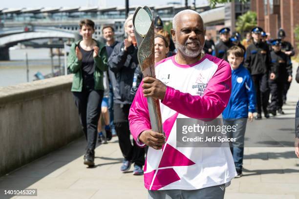 Batonbearer Henry Palton-Gaspard carries the Queen’s Baton on Thames Path during a relay from Blackfriars Pier to Paternoster Square, during the...