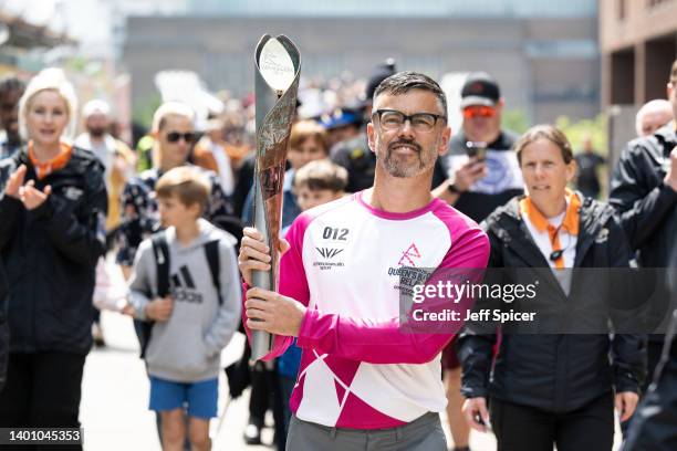 Batonbearer Nathan Oley carries the Queen’s Baton during a relay from Blackfriars Pier to Paternoster Square, during the Birmingham 2022 Queen’s...
