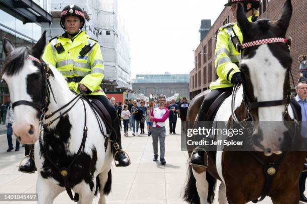 Batonbearer Nathan Oley carries the Queen’s Baton during a relay from Blackfriars Pier to Paternoster Square, during the Birmingham 2022 Queen’s...