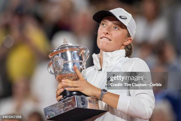 Iga Swiatek of Poland with the winners trophy after her victory against Coco Gauff of the United States during the Singles Final for Women on Court...