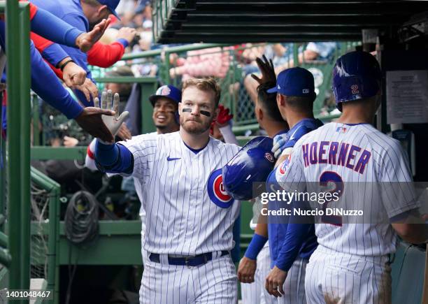 Ian Happ of the Chicago Cubs is congratulated by teammates after his sac fly scored Christopher Morel of the Chicago Cubs during the sixth inning of...