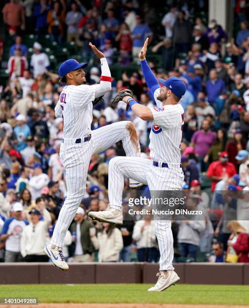 Christopher Morel and Patrick Wisdom of the Chicago Cubs celebrate their team win over the St. Louis Cardinals during Game One of a doubleheader at...