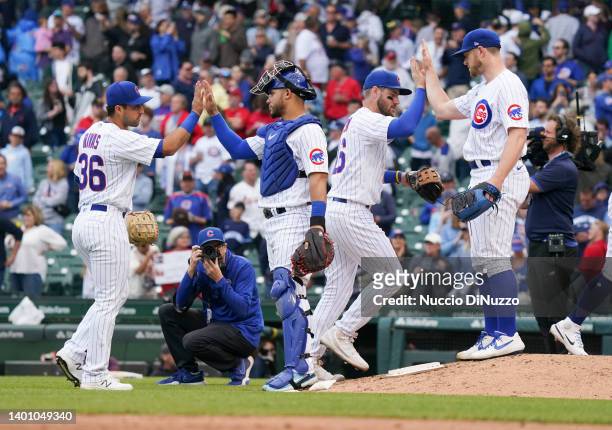 The Chicago Cubs celebrate their team win over the St. Louis Cardinals during Game One of a doubleheader at Wrigley Field on June 04, 2022 in...