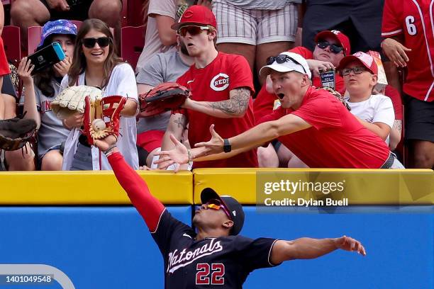 Juan Soto of the Washington Nationals leaps to make a catch at the wall in the first inning against the Cincinnati Reds at Great American Ball Park...