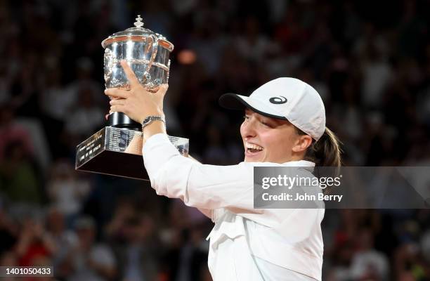 Iga Swiatek of Poland celebrates her victory during the trophy ceremony following the women's final against Coco Gauff of USA on day 14 of the French...