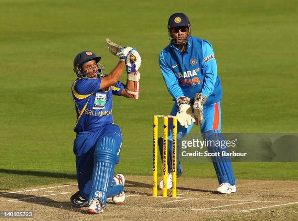 Tillakaratne Dilshan of Sri Lanka bats as wicketkeeper MS Dhoni of India looks on during the One Day International match between India and Sri Lanka...