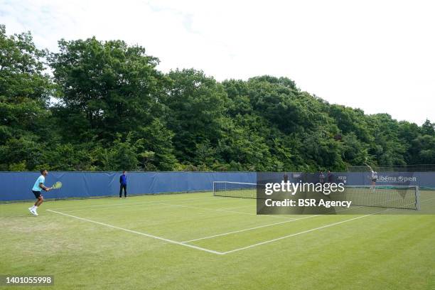 Botic van de Zandschulp of the Netherlands services against Felix Auger-Aliassime of Canada during a Practice Session of the Libema Open Grass Court...