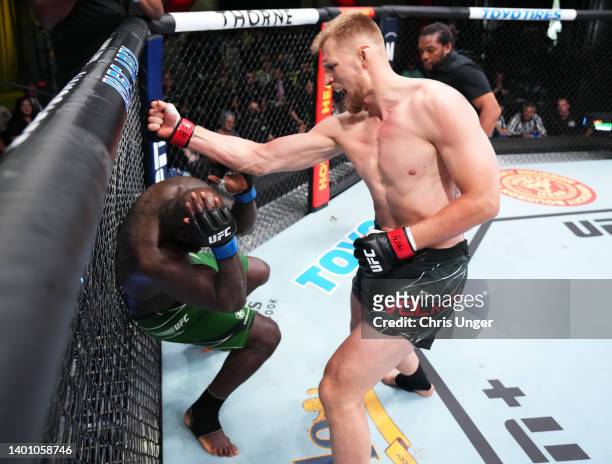 Alexander Volkov of Russia punches Jairzinho Rozenstruik of Suriname in a heavyweight fight during the UFC Fight Night event at UFC APEX on June 04,...