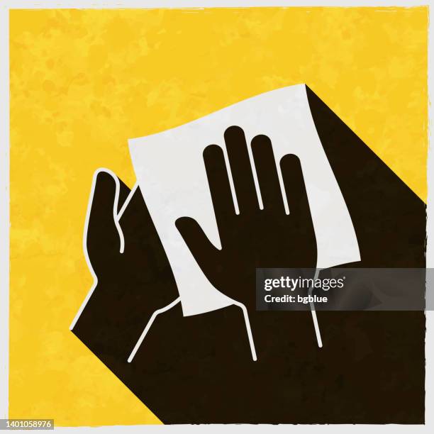 clean and sanitize hands with wipes. icon with long shadow on textured yellow background - kitchen paper stock illustrations
