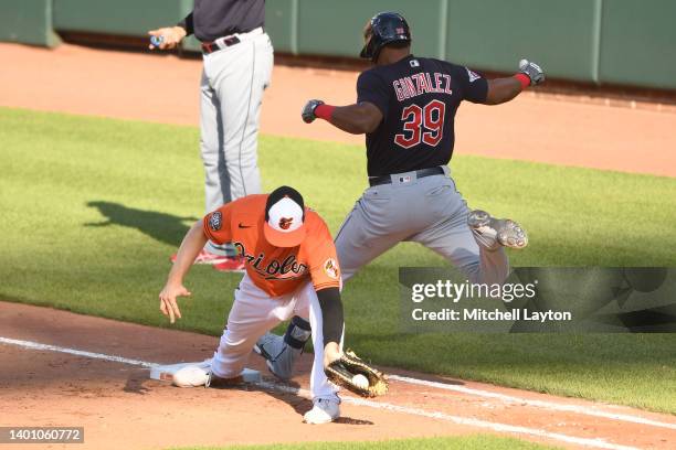 Trey Mancini of the Baltimore Orioles makes the catch to get Oscar Gonzalez of the Cleveland Guardians at first base in the seventh inning during a...