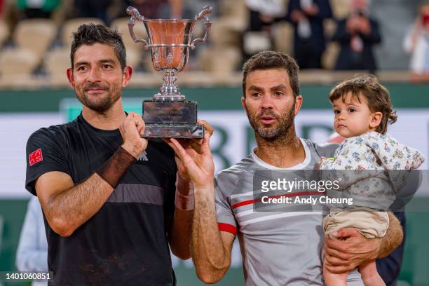 Jean-Julien Rojer of Netherlands and partner Marcelo Arevalo of El Salvador pose with the Jacques-Brugnon cup after winning Championship point...