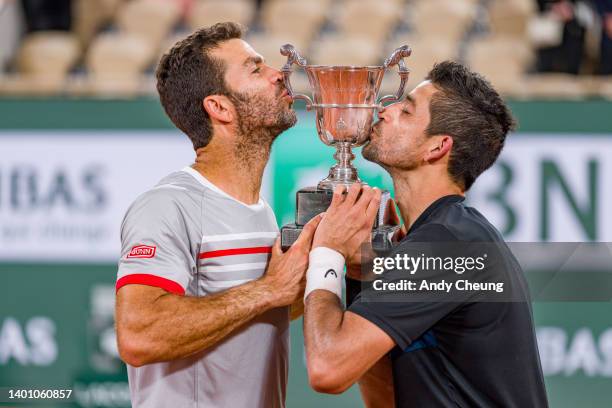 Jean-Julien Rojer of Netherlands and partner Marcelo Arevalo of El Salvador pose with the Jacques-Brugnon cup after winning Championship point...