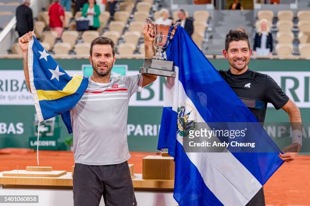 Jean-Julien Rojer of Netherlands and partner Marcelo Arevalo of El Salvador pose with the Jacques-Brugnon cup after winning Championship point...
