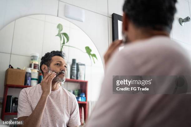 mature man applying shaving foam on face - man shaving foam stock pictures, royalty-free photos & images