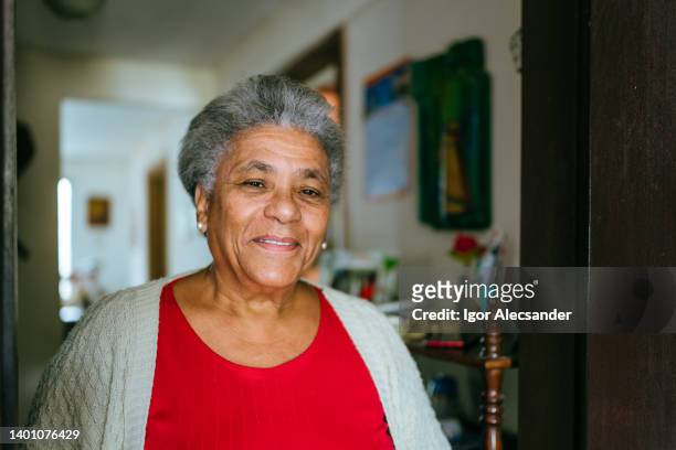 smiling elderly woman at home - humility stock pictures, royalty-free photos & images