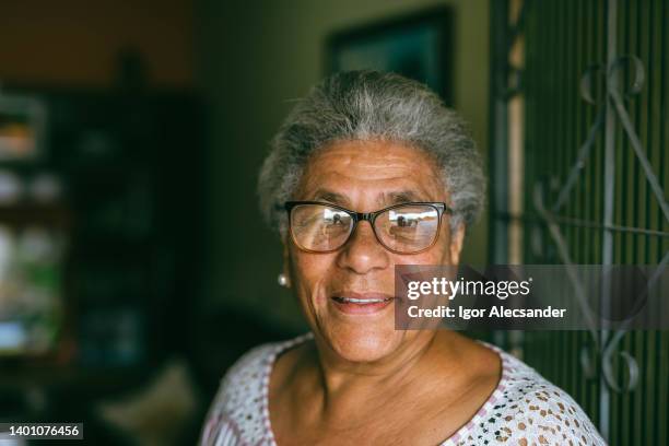 portrait of an elderly woman at home - stereotypical housewife bildbanksfoton och bilder
