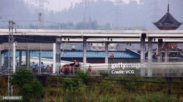 Rescuers work at the accident site of a train that derailed after being hit by mud and rockslide at Rongjiang Railway Station on June 4, 2022 in...