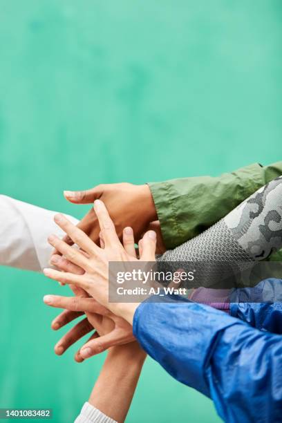 group of women friends stacking hands after workout - hand stack stock pictures, royalty-free photos & images