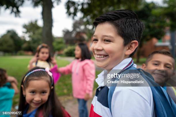 group of children arriving to their school and looking very happy - junior high student stock pictures, royalty-free photos & images