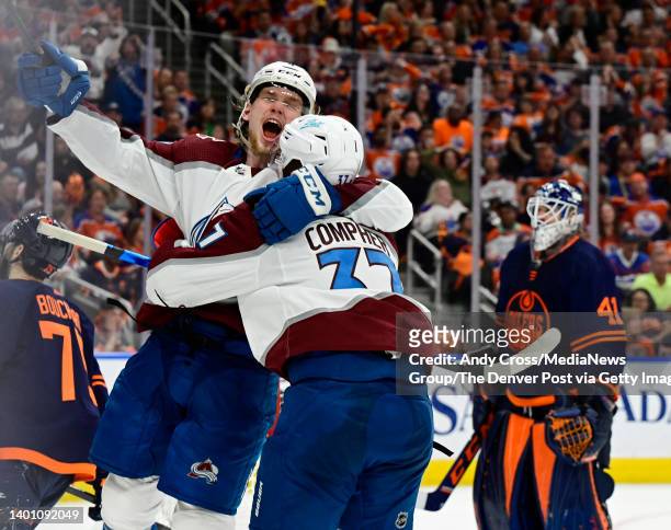 Colorado Avalanche defenseman Bowen Byram , left, celebrates with J.T. Compher, after Compher scored the game winning goal against Edmonton Oilers...