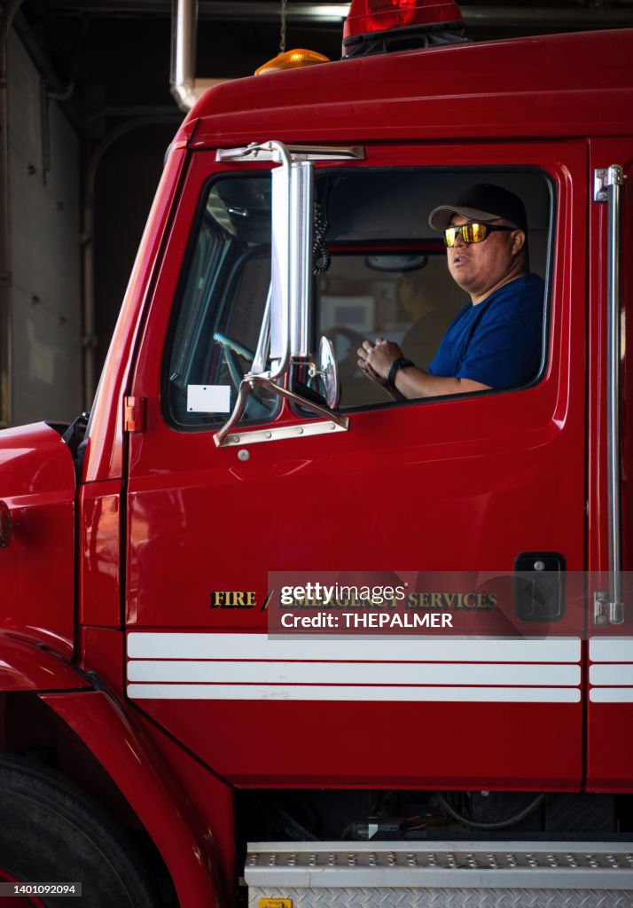 Firefighter inside a fire engine vehicle