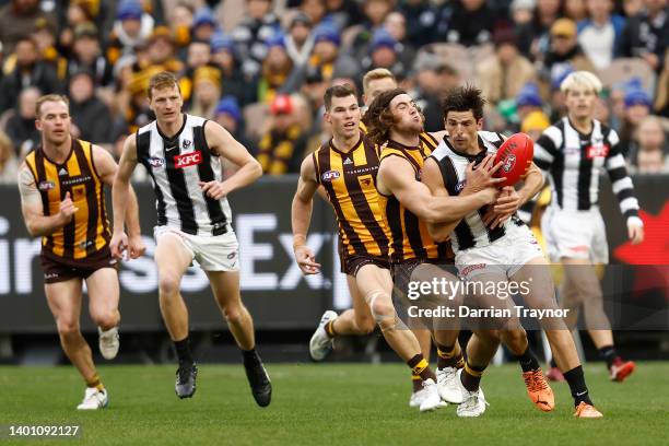 Jai Newcombe of the Hawks tackles Scott Pendlebury of the Magpies during the round 12 AFL match between the Hawthorn Hawks and the Collingwood...