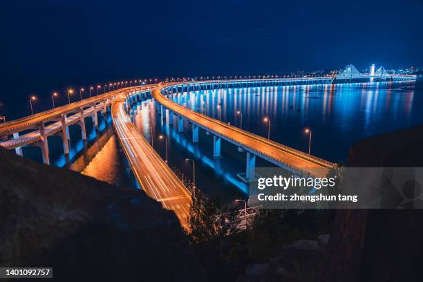 cross-sea bridge at night. - light trail imagens e fotografias de stock