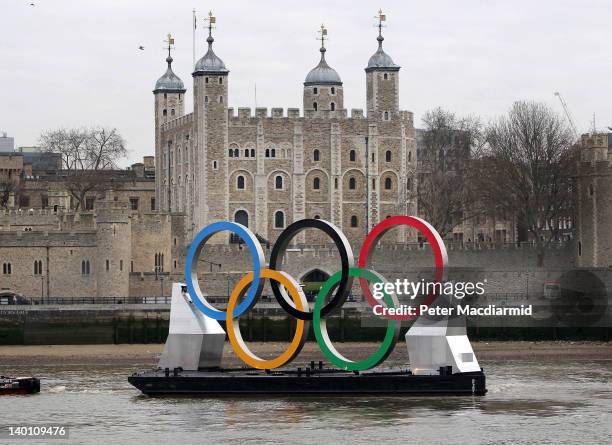 Giant Olympic rings are towed on The River Thames past The Tower of London on February 28, 2012 in London, England. With 150 days remaining before...