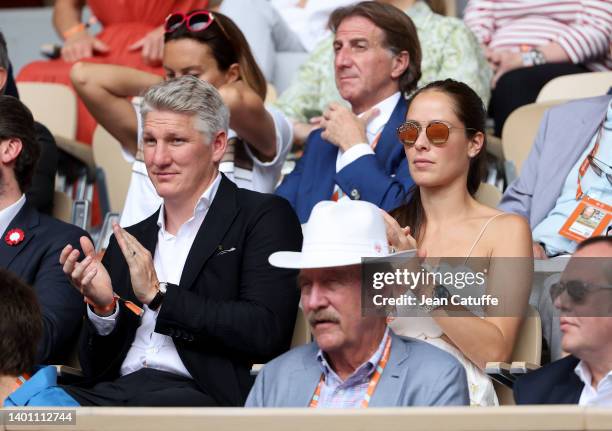 Bastian Schweinsteiger and his wife Ana Ivanovic, below Stan Smith attend the women's final on day 14 of the French Open 2022 held at Stade Roland...