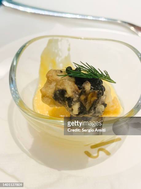 crispy rock oyster with champagne butter sauce - amuse bouche stockfoto's en -beelden