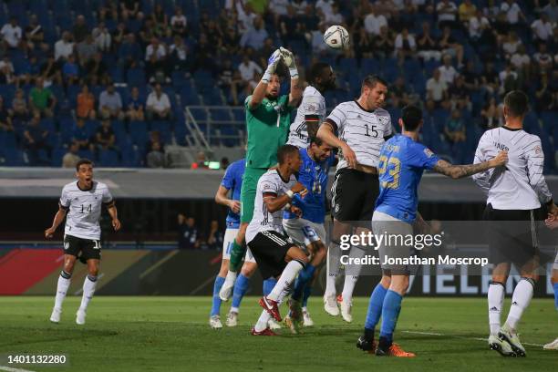 Gianluigi Donnarumma of Italy clashes with Antonio Rudiger of Germany as he jumps to catch an aerial ball with the Italian goalkeeper subsequently...