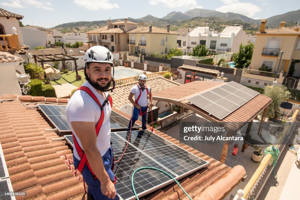 Installation of solar panels on the roof of a house, maintenance and cleaning with vertical works