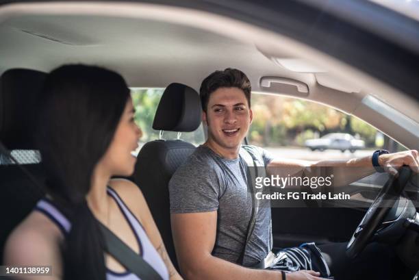 couple talking inside a car - man sitting inside car stock pictures, royalty-free photos & images