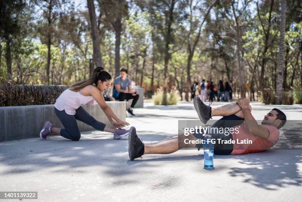 couple stretching at the park - self control stock pictures, royalty-free photos & images
