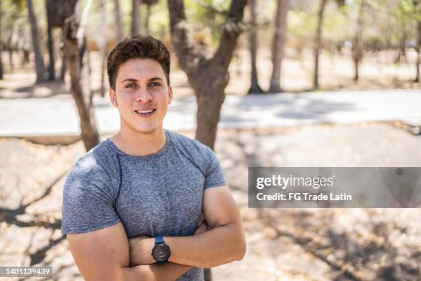 portrait of a young sporty man at park - self control stock pictures, royalty-free photos & images